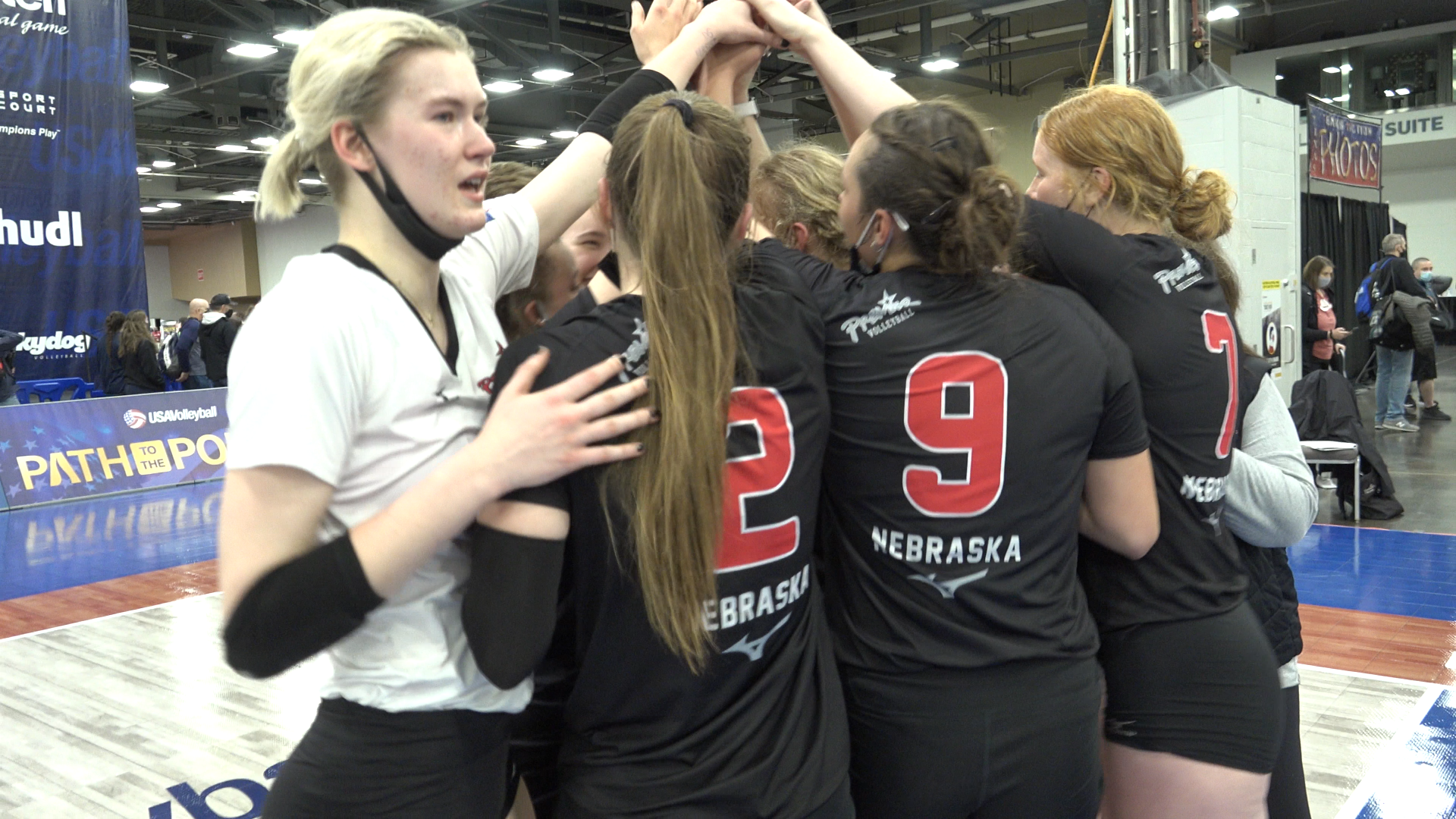 Premier Nebraska 18 Gold huddle and celebrate together after winning the 18 Open Division National Championship.