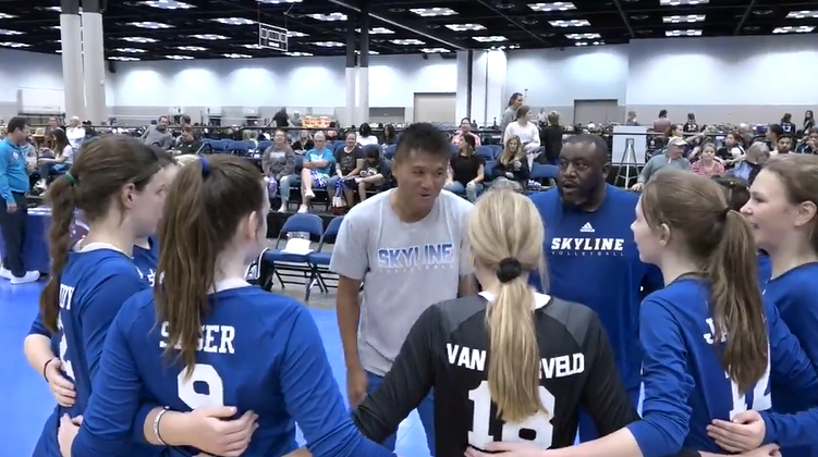 coaches talking to girls in huddle