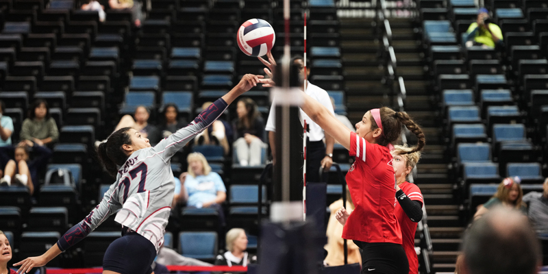 two girls at the net attacking across it